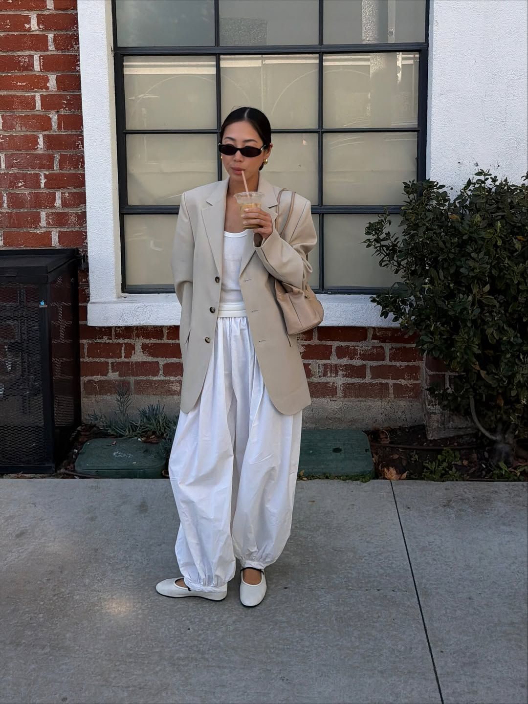 Aimee Song in white balloon pants.