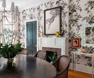 Wooden dining table and chairs, white fireplace, green door