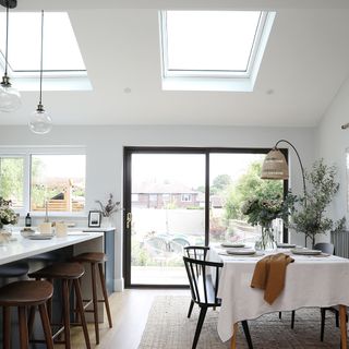 Kitchen and dining room with slanted ceiling windows