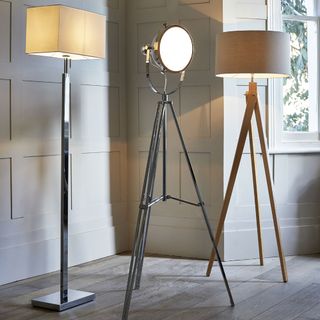 room with tripod lampshade with white walls
