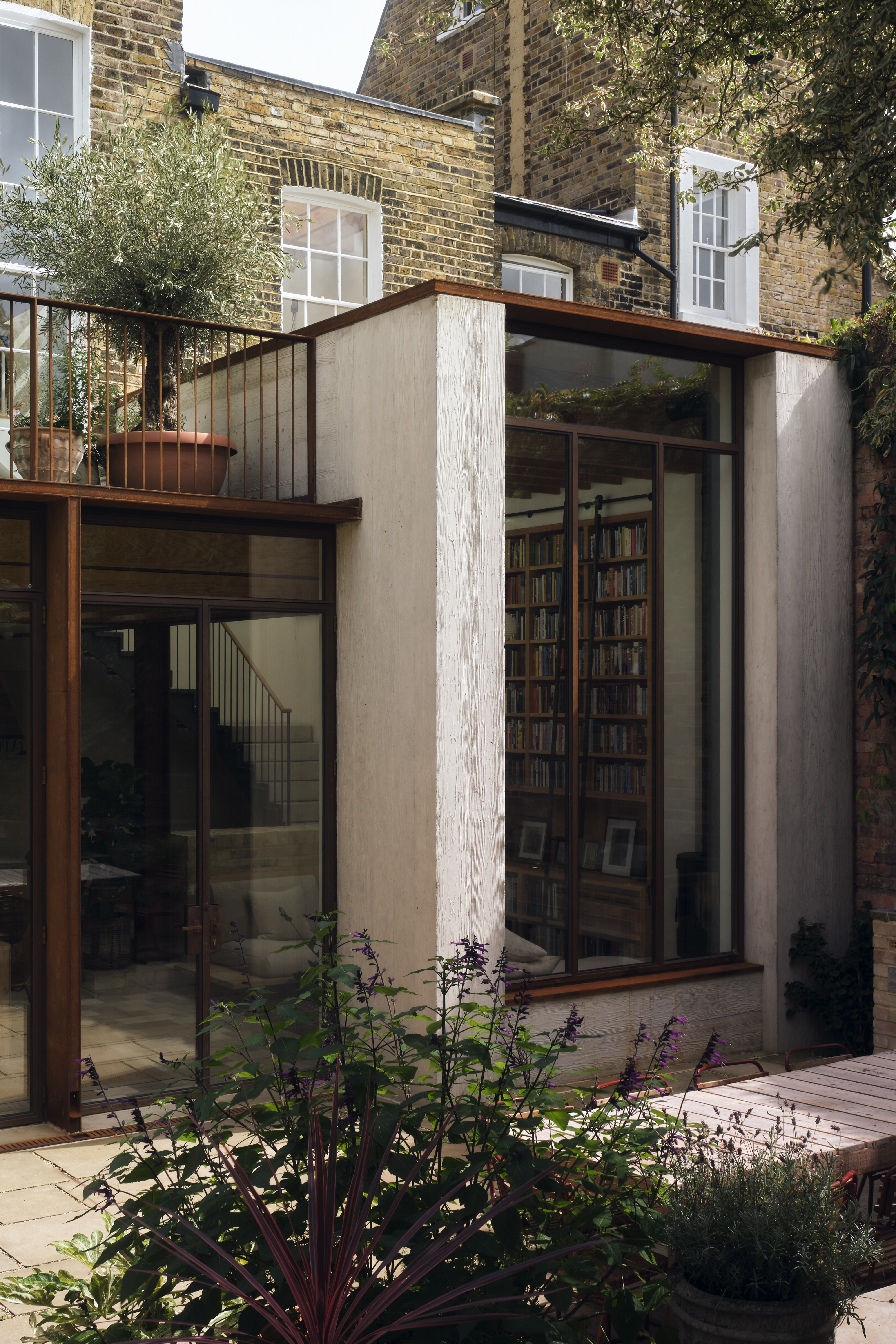 modern extension on a Victorian London home, with glass panels and copper details
