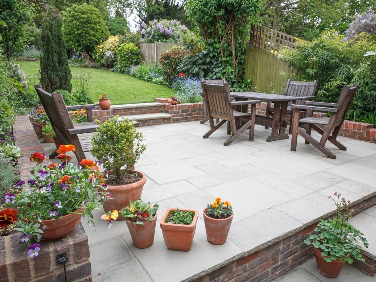 Potted Plants And Flowers On An Outdoor Patio