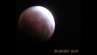 Live Science reader Michael Hunter snapped this photo showing the partial eclipse phase in Fremont, California. Hunter noted that he never changed his camera's time for Daylight Saving, so the timestamp is an hour early (it was really 3:51 a.m. PDT). During this phase, the moon was still entering the Earth's dark umbral shadow. "[The] moon was about to pass behind [the] rooftop, causing difficulty to focus," Hunter told Live Science. But you can still see the moon's reddish tint.