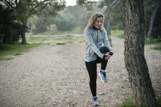Woman exercising outdoors to beat weight-loss plateau