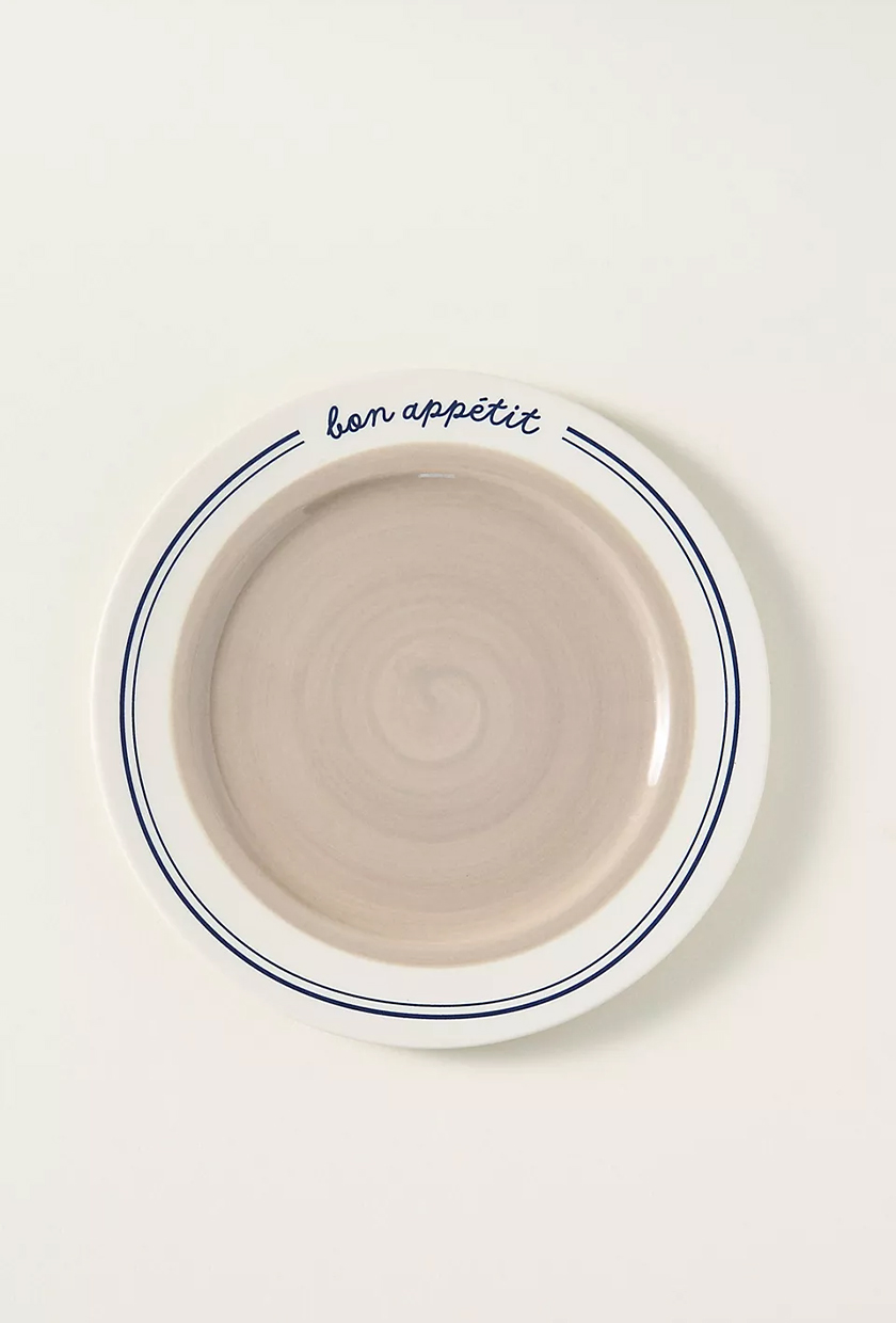 White, beige, and blue plate with "bon appetit" in cursive from Anthropologie