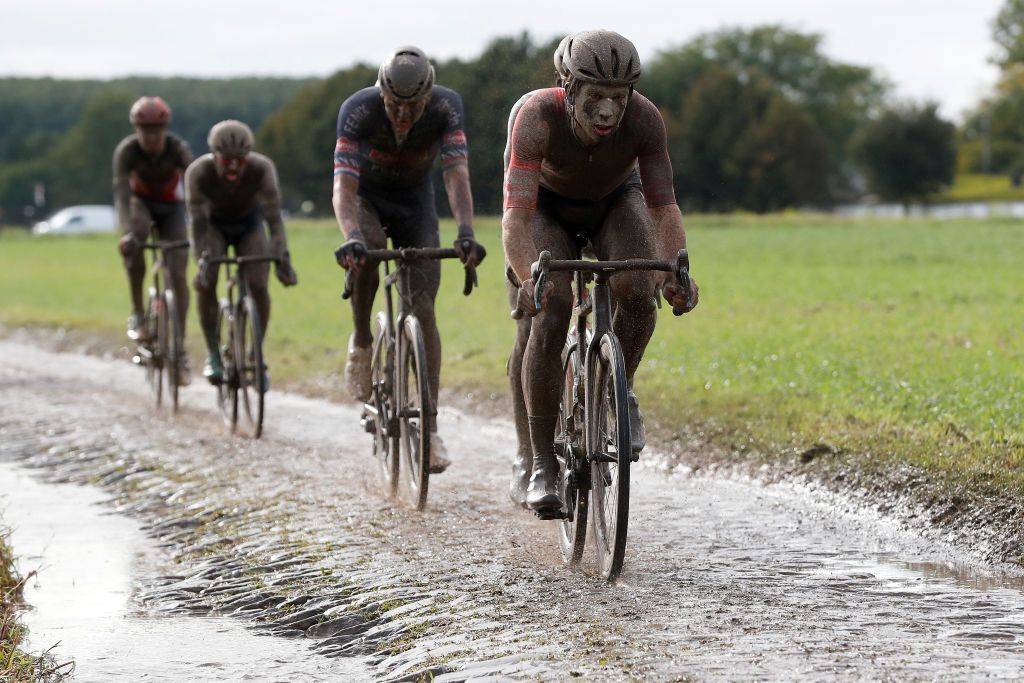 ROUBAIX FRANCE OCTOBER 03 Guillaume Boivin of Canada and Team Israel StartUp Nation covered in mud competes in the chase group through cobblestones sector during the 118th ParisRoubaix 2021 Mens Eilte a 2577km race from Compigne to Roubaix ParisRoubaix on October 03 2021 in Roubaix France Photo by Bas CzerwinskiGetty Images