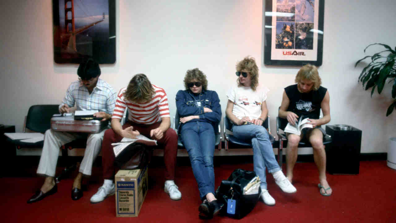 Def Leppard posing for a photograph backstage in the 1980s