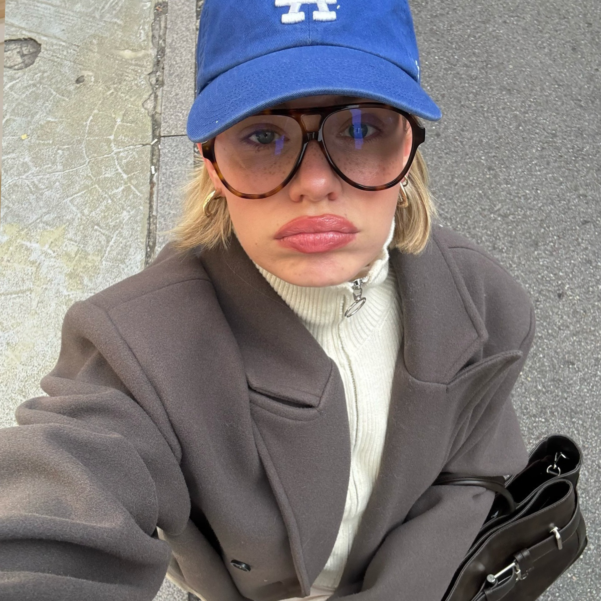 Linda Sza wears the zip-up funnel neck jacket trend.