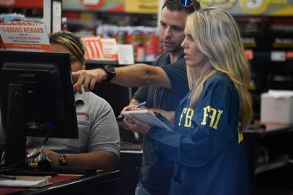 FBI agents search for clues and evidences at the Auto Zone Store in Plantation, North of Miami, on October 26, 2018 where a suspect was arrested in connection with the 12 pipe bombs and suspi