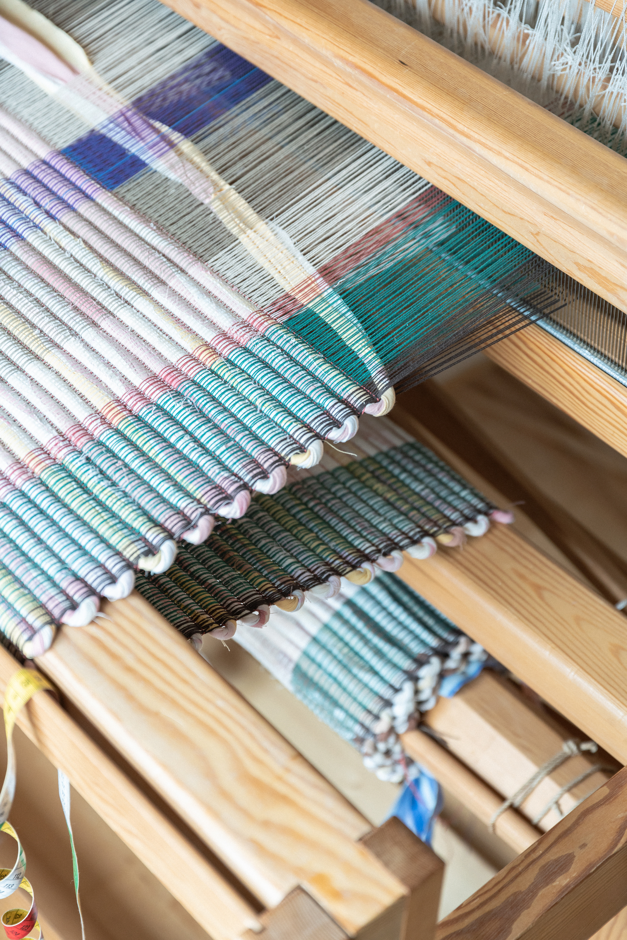 A close up of a woven section of Bacterial Cellulose Fibre on a wooden loom.