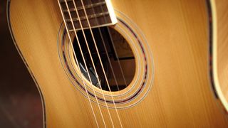 Close-up of the soundhole of an acoustic guitar