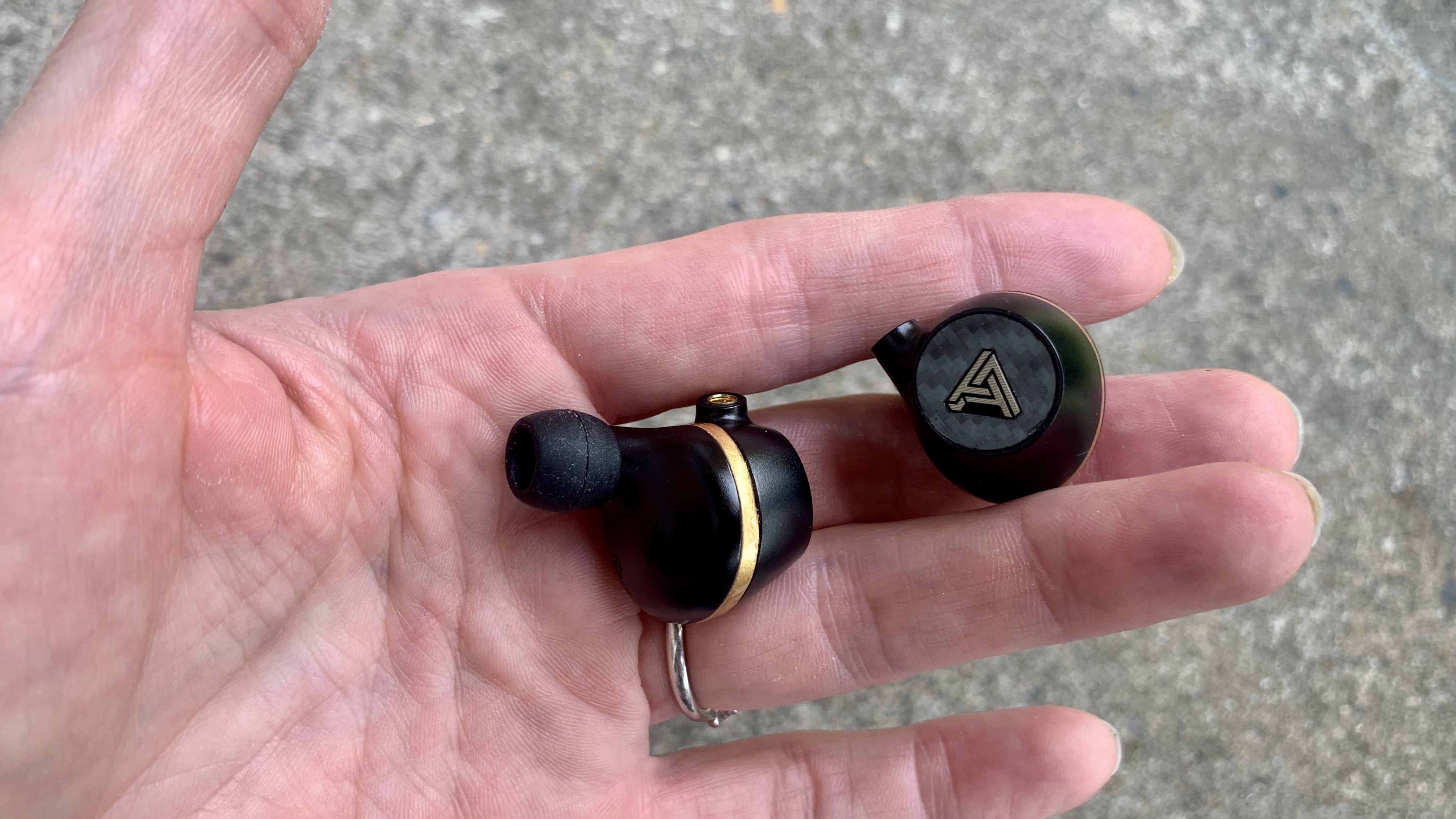 Audeze Euclid held in a woman's hand