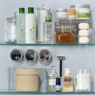 bathroom shelves with cotton wool and ear buds in glass storage jars
