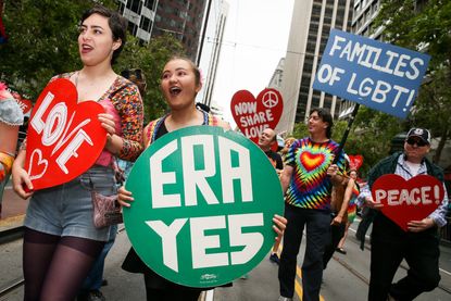 A woman holds a sign that says "ERA YES."