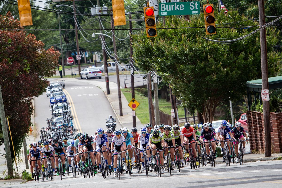 The women's peloton is spread across the road at the Winston-Salem Classic.