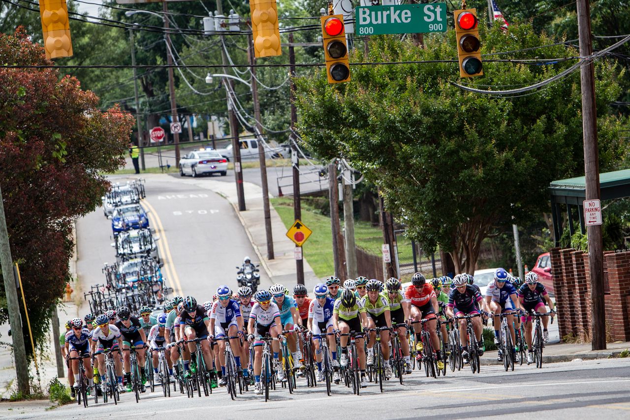 The women's peloton is spread across the road at the Winston-Salem Classic.