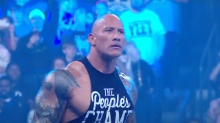The Rock standing in the ring during his return on WWE Smackdown.