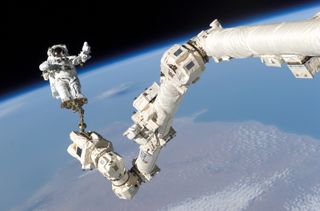 The International Space Station's Canadarm2, seen here with astronaut Steven Robinson during the STS-114 shuttle mission in 2005, has inspired new surgical tools for use on Earth.