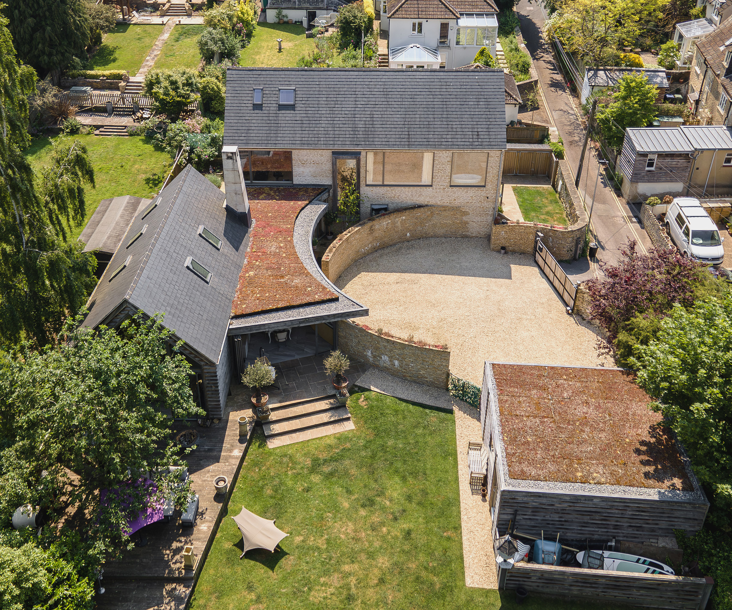 Drone shot of a self build plot with large driveway and garage building