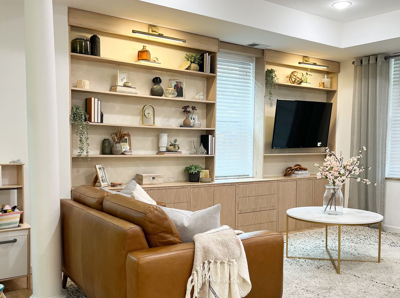 A living room with build in panelled shelving