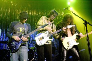 (from left) Joe Satriani, Steve Vai and Yngwie Malmsteen perform onstage in Chicago, Illinois on October 24, 2003