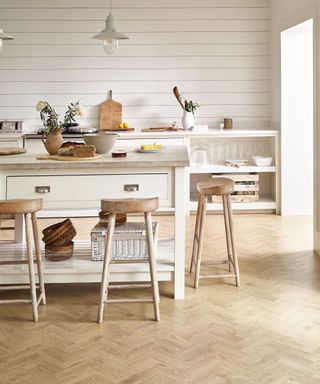 Vinyl wood-like kitchen flooring ideas in a cream and pale wood scheme.