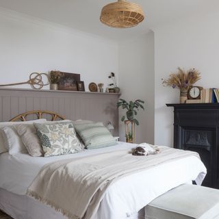 master bedroom with white wall and bedlinen