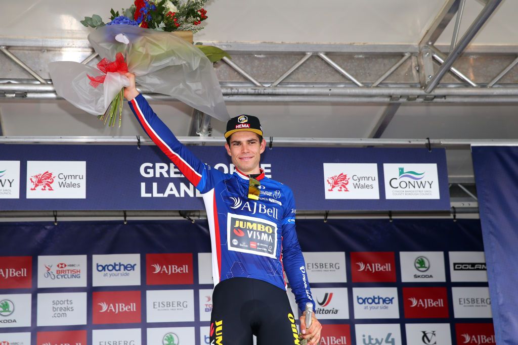 LLANDUDNO SEPTEMBER 08 Wout Van Aert of Belgium and Team Jumbo Visma celebrates winning the blue leader jersey on the podium ceremony after the 17th Tour of Britain 2021 Stage 4 a 210km stage from Aberaeron to Great Orme Llandudno 1306m TourofBritain TourofBritain on September 08 2021 in Llandudno United Kingdom Photo by Alex LiveseyGetty Images