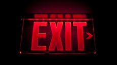 A red exit sign against a black background.