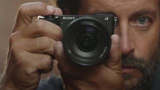 Sony A6700 in the hand of photographer holding viewfinder up to their eye