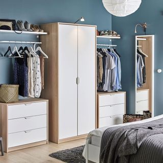 blue room with wooden wardrobe and blue walls