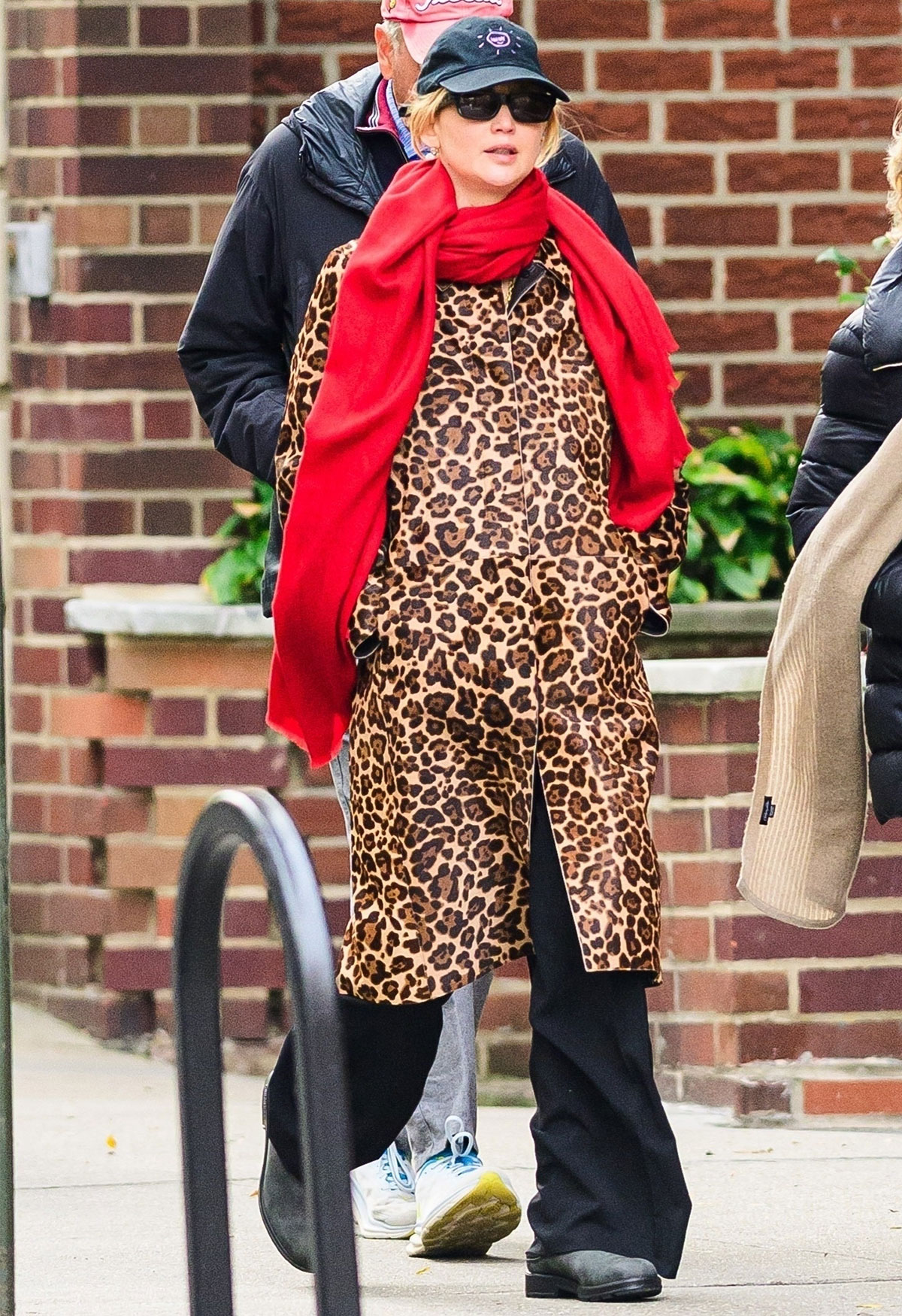 Woman wearing the animal-print coat trend of fall/winter 2025.