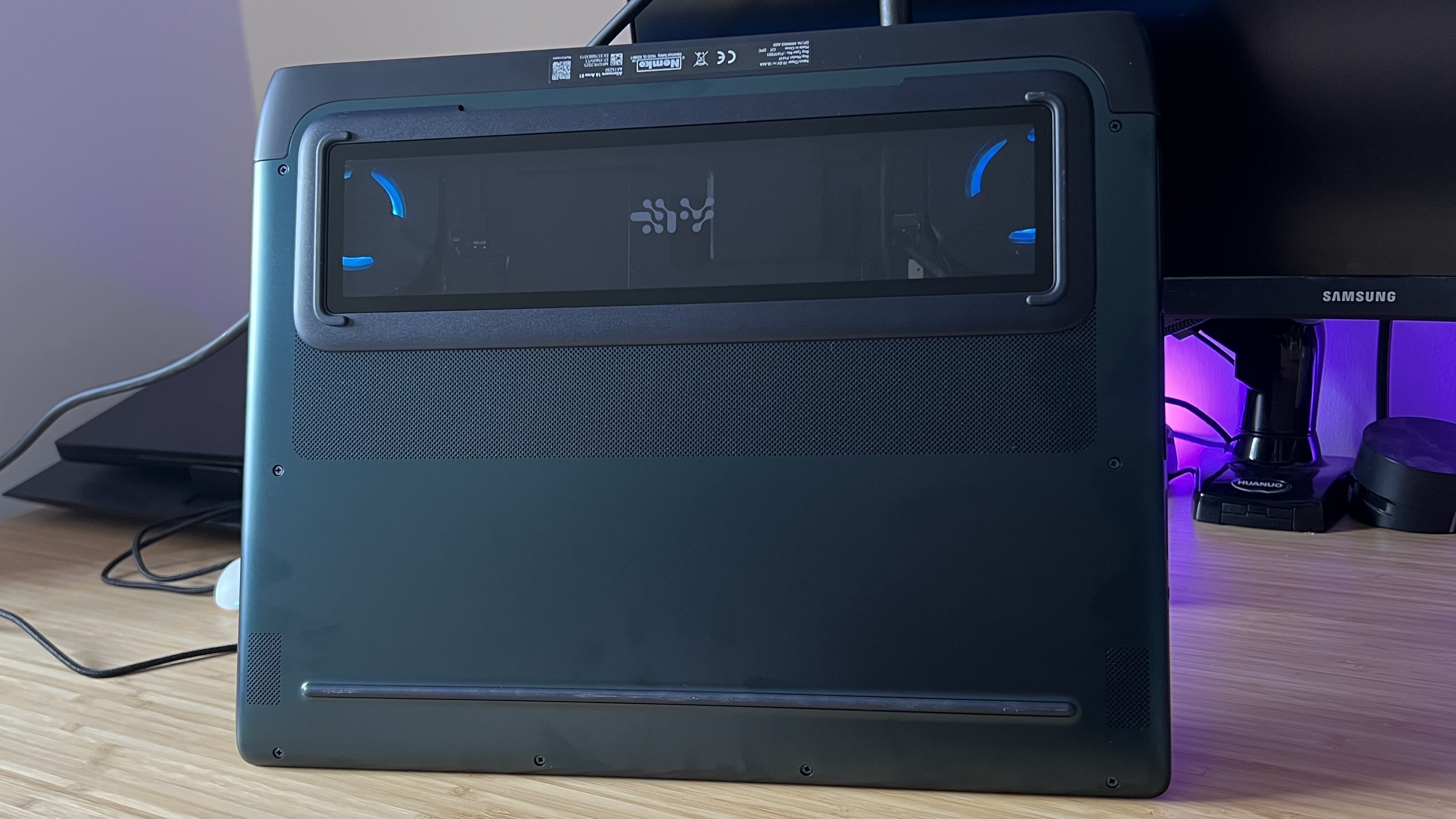 Underside of Alienware 16 Area-51 gaming laptop with glass viewing window and RGB fans
