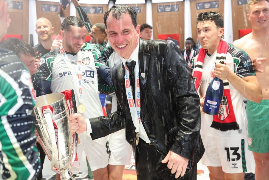 LONDON, ENGLAND - MAY 24: Sunderland head coach R&amp;Atilde;&amp;copy;gis Le Bris is soaked with champagne as the team celebrate in the dressing room after winning the Sky Bet Championship Play-Off Final match between Sheffield United FC and AFC Sunderland at Wembley Stadium on May 24, 2025 in London, England. (Photo by Ian Horrocks/Sunderland AFC via Getty Images)