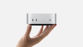 Hand holding Mac mini