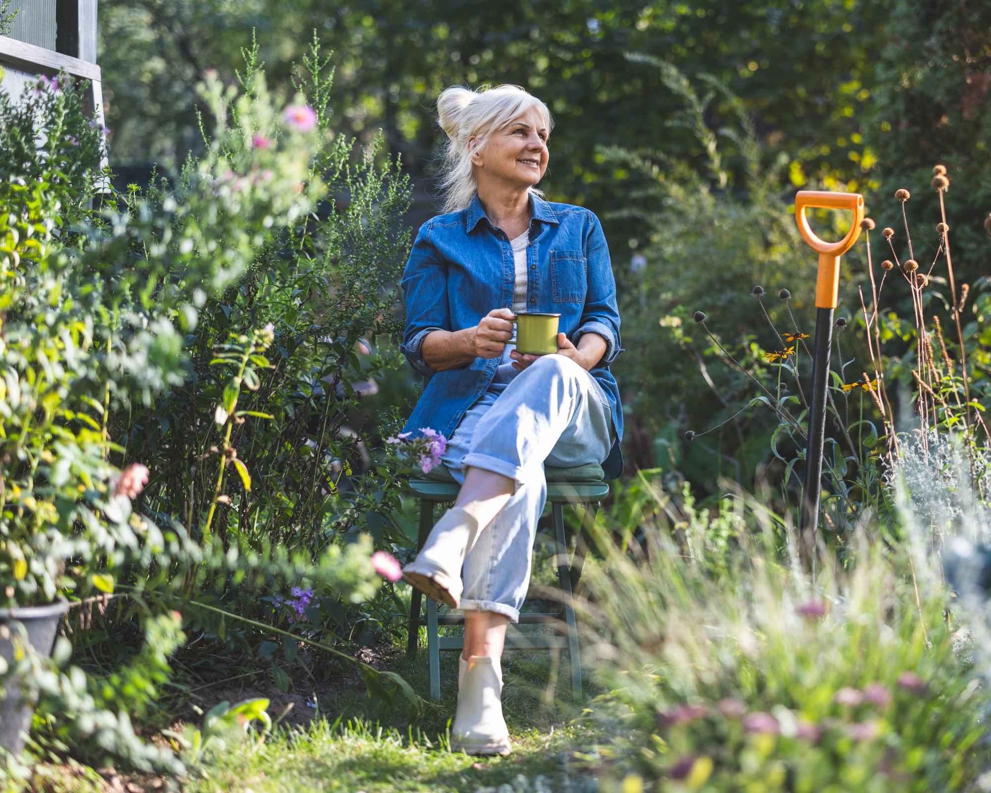 woman relaxing in garden with a cup of tea