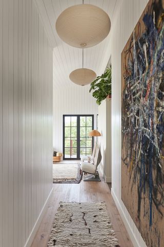 white hallway with large abstract artwork
