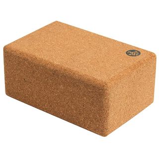 Manduka cork yoga block on white background