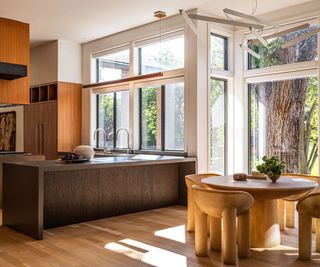 eat-in kitchen with round table and chairs in window with main kitchen beyond