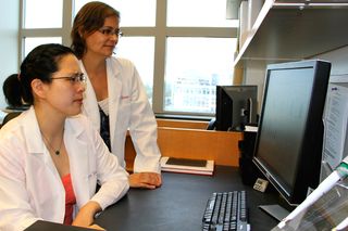 Joanne Turner, right, looks at data with graduate student Cynthia Canan at The Ohio State University Wexner Medical Center. Turner and her team recently discovered that daily doses of ibuprofen dramatically reduced inflammation in the lung cells of mice. The findings could hold promise in helping elderly people ward off infections.