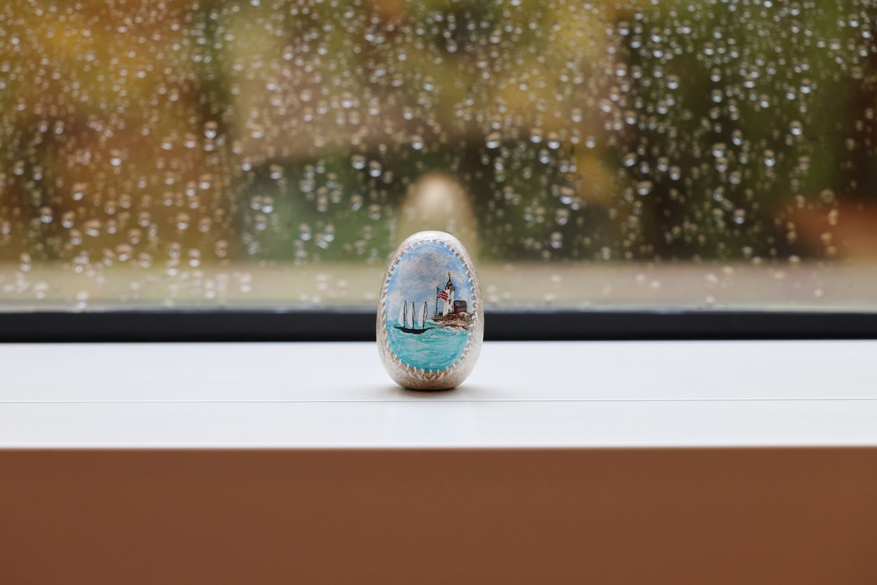 Painted stone in front of a window