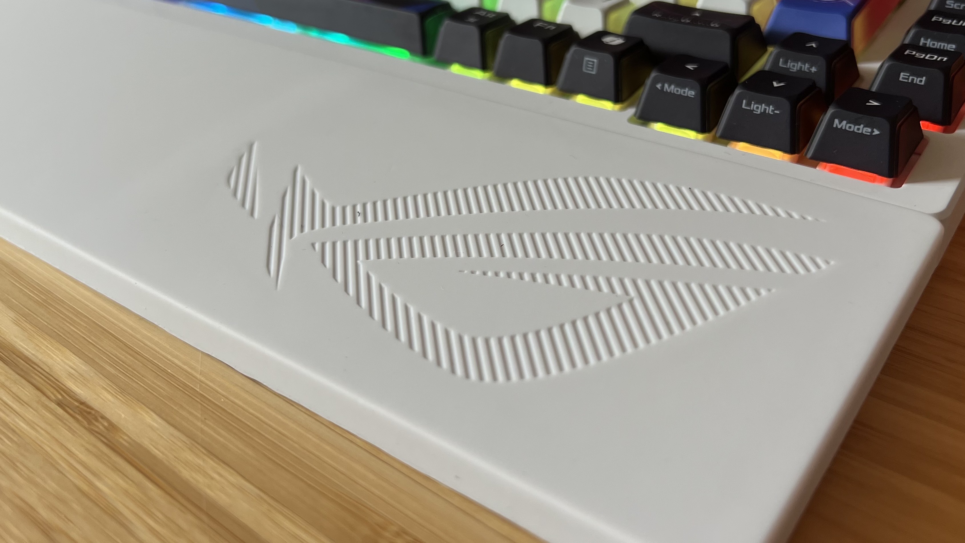 Asus ROG Azoth X wrist rest with close up on embossed logo