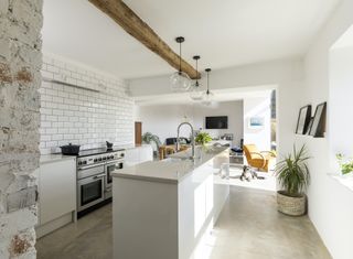 The kitchen design was left intentionally minimal with the view to spend more on quality materials for the Silestone worktop and appliances. The pendant lights were found on eBay and the white metro tiles are from Mandarin Stone.