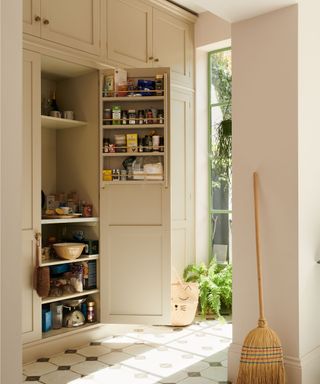 neutral pantry cupboard in a boot room meets utility that opens onto the garden