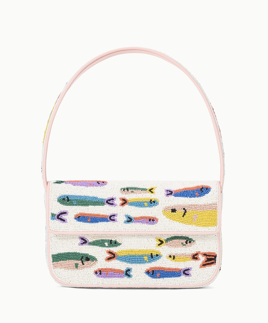 a beaded bag decorated with Sardines in front of a plain backdrop