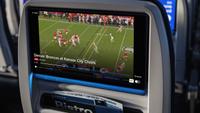 United airlines seat showing NFL football game. 