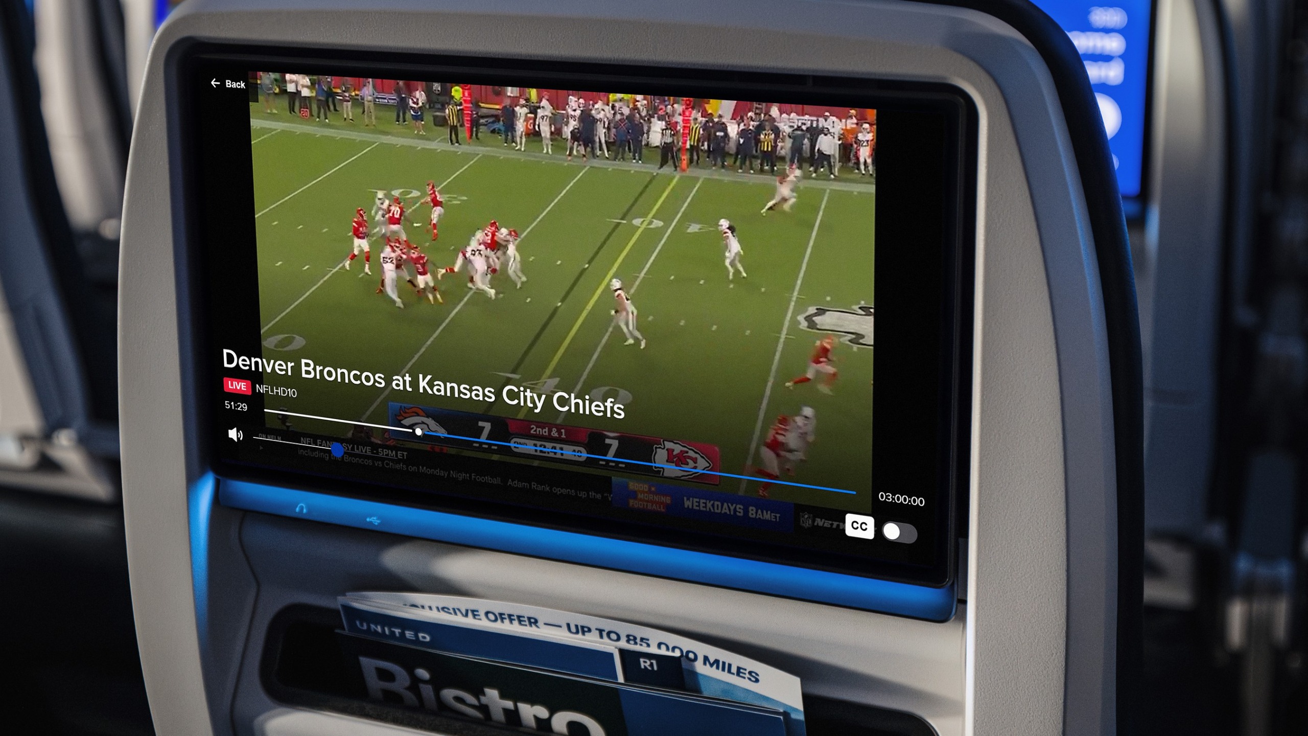 United airlines seat showing NFL football game. 