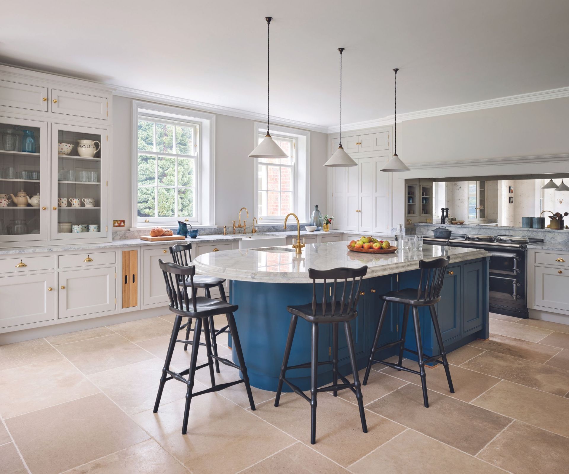 Blue kitchen island base, white cabinets and lights