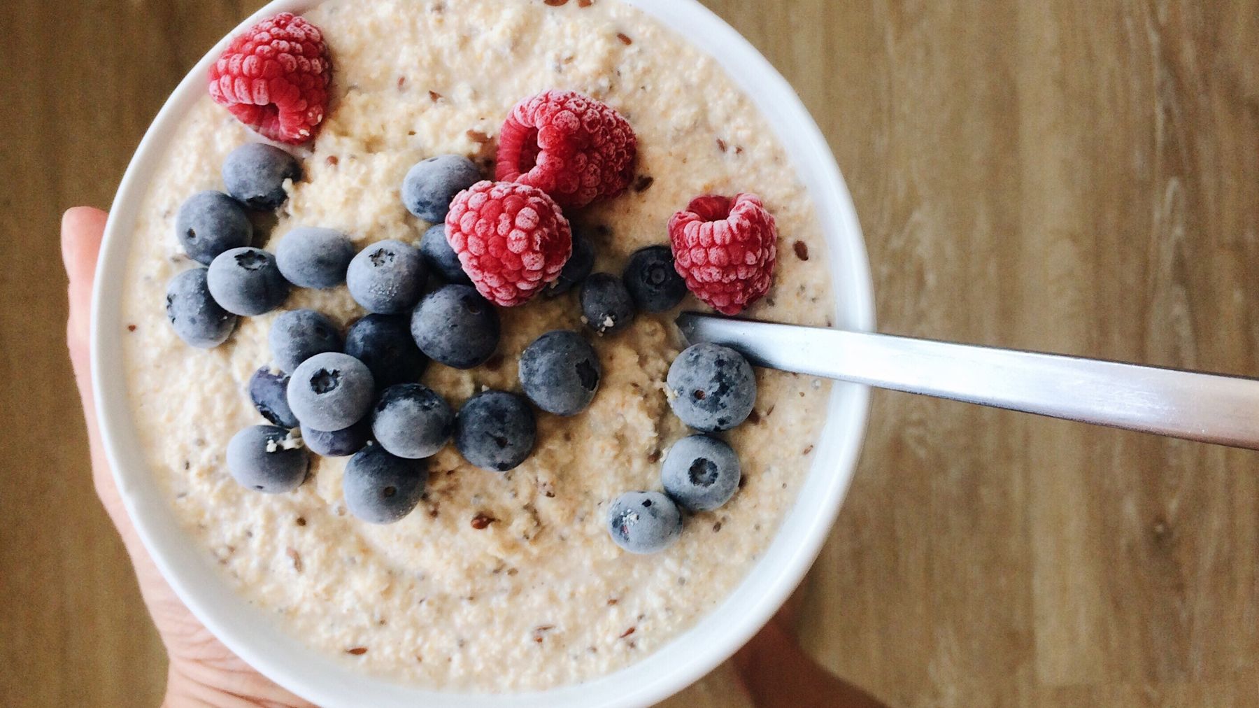 A bowl of porridge topped with fruit