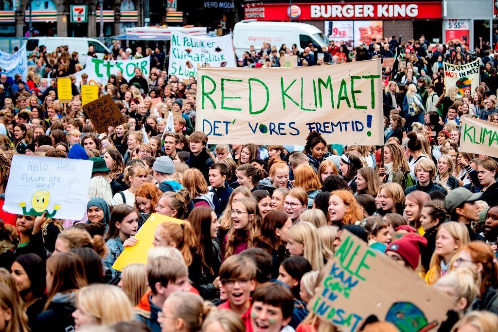 People demonstrate with placards during the Global Climate Strike at Raadhuspladsen in Copenhagen, Denmark, on September 20, 2019.